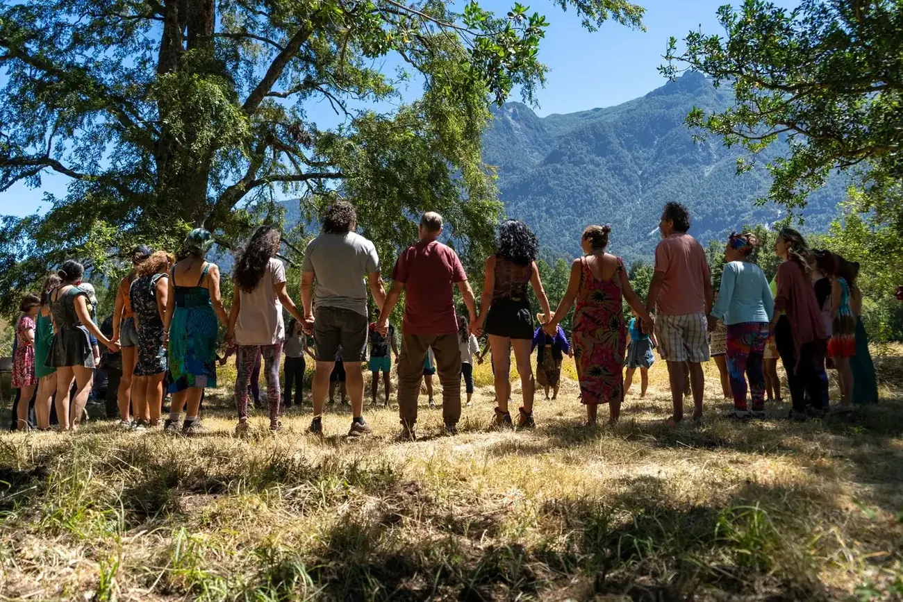La ronda completa tomada de la mano frente al cerro